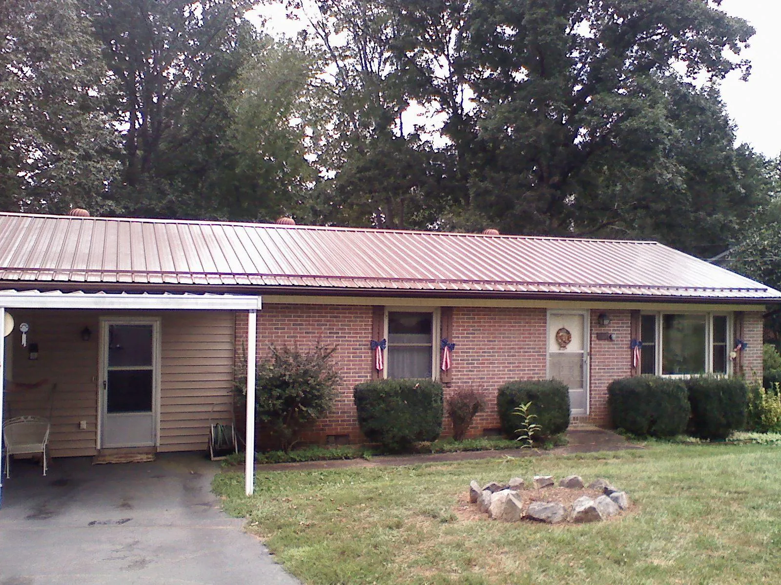 Bronze metal roof and carport on a brick ranch home — Roof Repair work by our crew in West Friendship