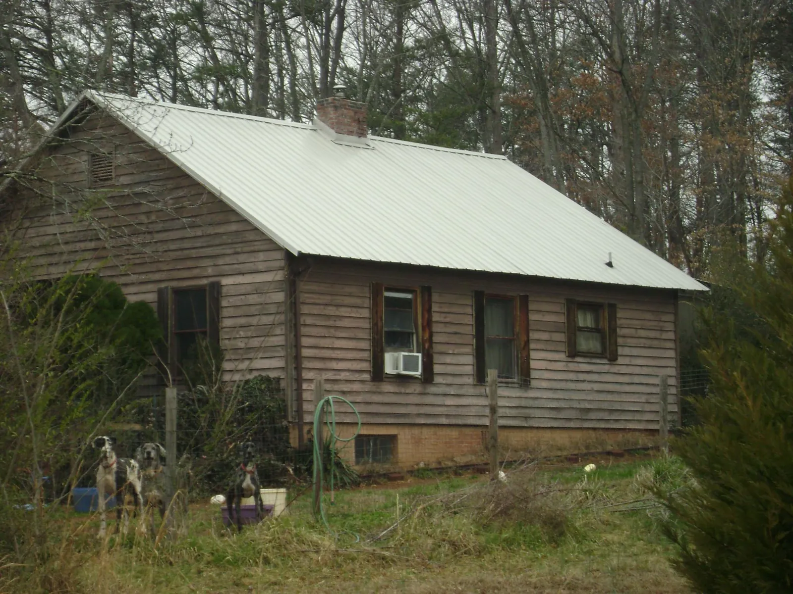White metal roof on an old wood sided farmhouse, from a Metal Roof Installation job in West Friendship